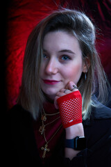 Beautiful portrait of a young girl on a black and red background
