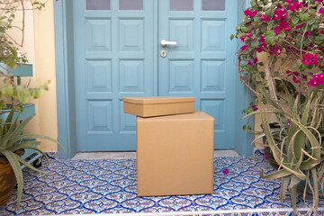 Two sealed, neatly placed packages on recipient house porch, close up, no people. Contactless,...