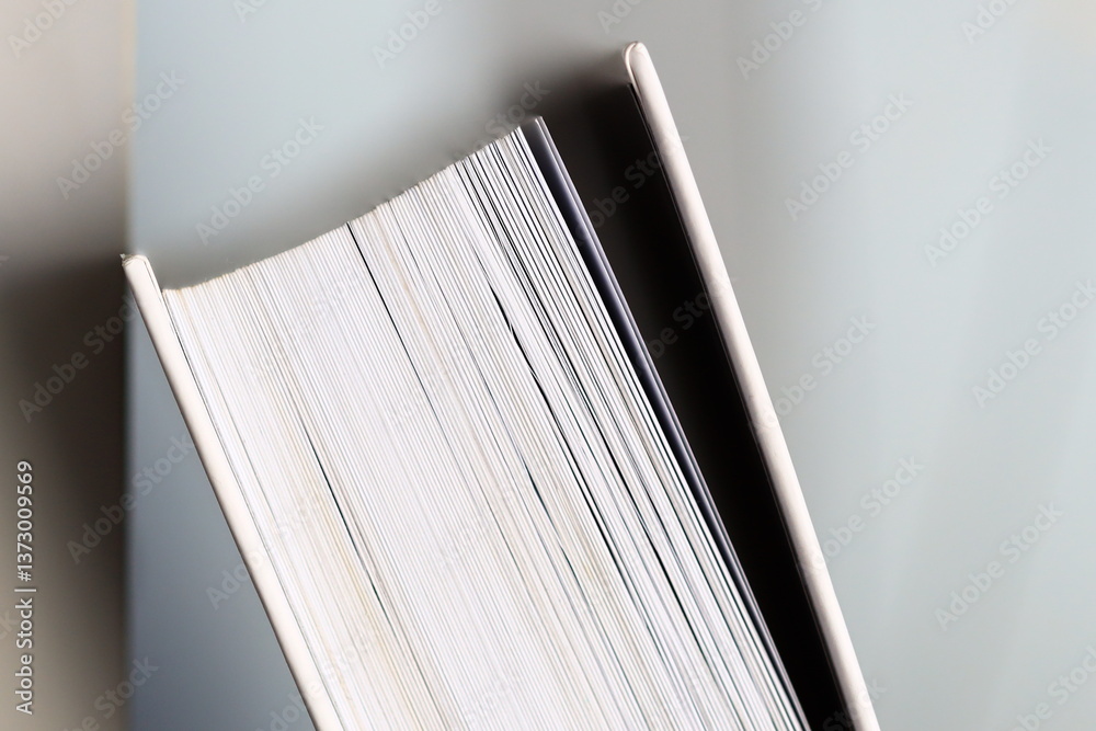 Aufkleber A close-up shot of a book lying on a table, perfect for using as an element in your design or for representing reading and learning.