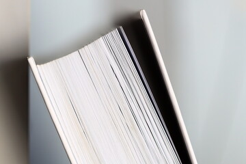 A close-up shot of a book lying on a table, perfect for using as an element in your design or for...