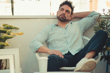 young man relaxing on an outdoor terrace