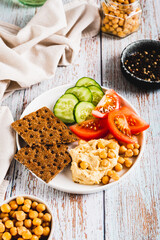Vegetarian plate with chickpeas and vegetables on the table vertical view