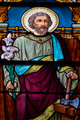 Naklejka premium Stained glass (19th century) of Saint joseph craftsman in his workshop.