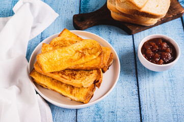 Traditional fried french toasts on white plate on table