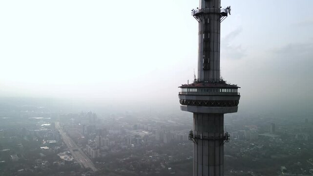Kok Tobe TV Tower. Mountainous terrain. The view from the drone. Spring time. Clouds and smog.