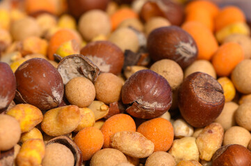 Colorful assortment of nuts and seeds creates a vibrant display in a local market setting