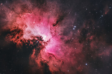 Red and pink nebula in space, showing cosmic dust and stars. Represents the vastness and beauty of the universe, perfect for astronomy or space exploration themes