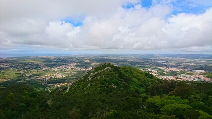 A breathtaking panoramic view showcasing Castle of the Moors and lush green hills