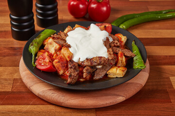 Turkish-Style Kebab with Buttered Flatbread and Grilled Meat in Cast Iron Skillet