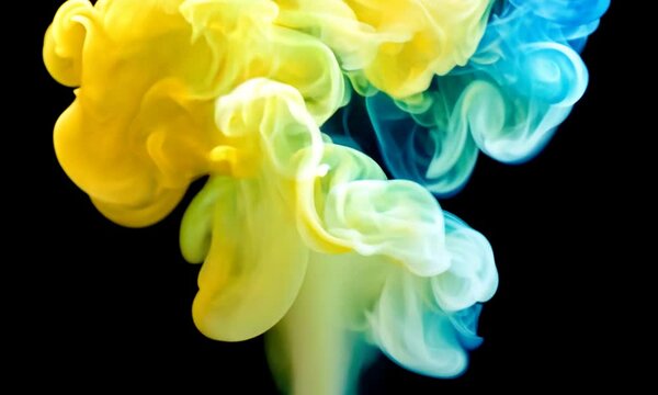 Yellow and blue colored smoke rising up - 4K isolated on black background with alpha mask pass