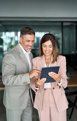 Corporate managers talking meeting working together in lobby. Two mature professional executives...