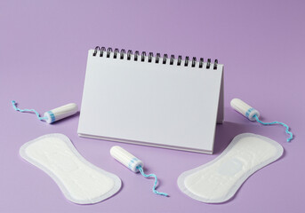 Menstrual Pads and Tampons with Calendar on Purple Background representing menstrual hygiene and period products for feminine care and women's health