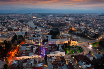 Fototapeta premium Evening drone view of the ancient city of Kutaisi, located on the two banks of the Rioni River and a center of culture, Georgia