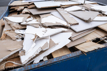  heap of shattered drywall and gypsum decorations is removed as construction waste. Broken building...