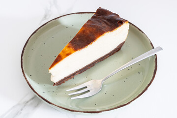 Slice of cheesecake served on a plate with a fork