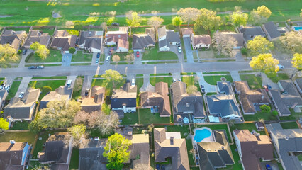 Vacant land and grass lined drainage channel near residential neighborhood suburban houses in...