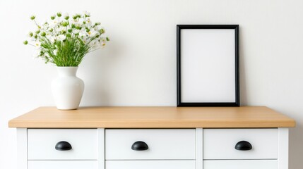 White Dresser with Blank Frame and Daisies in White Vase