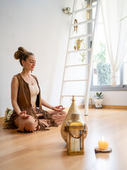 Engaging in Serene Meditation in a Tranquil Space Illuminated by Soft Candlelight
