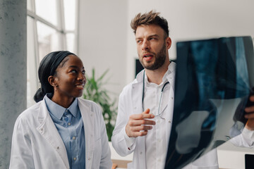Doctors examining x ray of patient in hospital or clinic