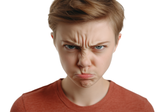 Frustrated young person making an angry expression against a plain background while showcasing intense emotions in a close-up shot