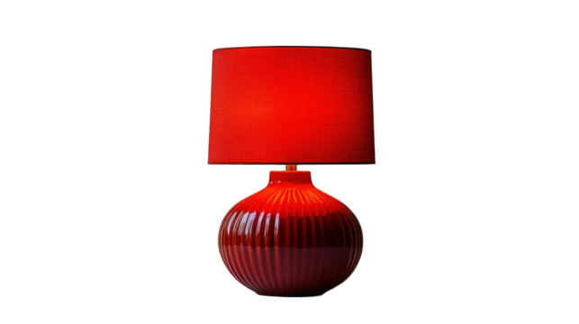 Red table lamp positioned on a white background