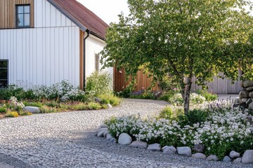 Beautiful stone pathway winding through a vibrant garden leading to a modern home in a serene rural setting during a sunny afternoon