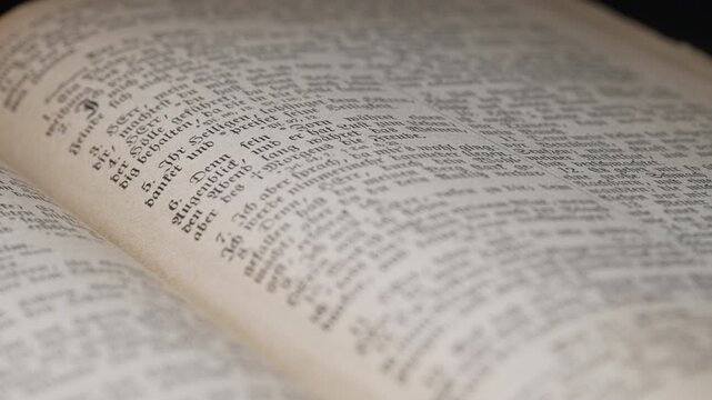 Opened saved old german paper book with Gothic font ancient writings. Worn Pages