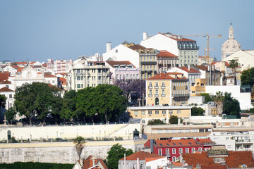view from gracas to the famous viewpoint Miradouro de S&atilde;o Pedro de Alc&acirc;ntara in lisbon in the warm morning light