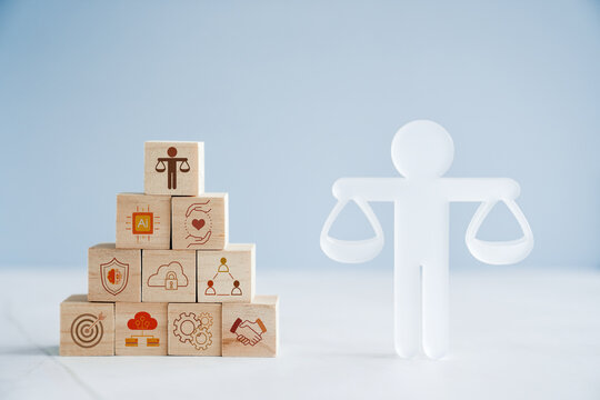 Hand holding wooden block with Ethical icons, business ethics and corporate compliance concept

