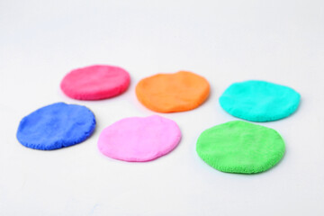Different colorful play dough on white background, closeup