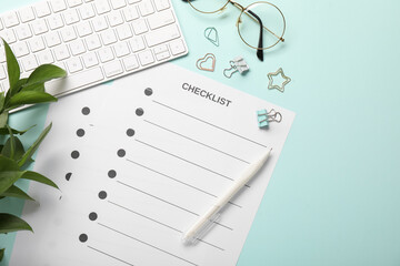 Checklist, keyboard, glasses, leaves and paper clips on light blue background, flat lay