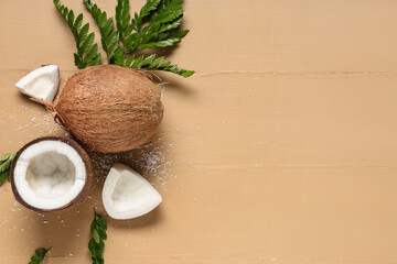 Fresh coconuts and leaves on brown wooden background