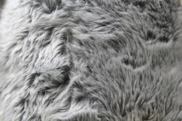 Grey gray plush faux fur fabric material textured background close-up abstract