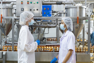 Quality control inspectors reviewing canned food production