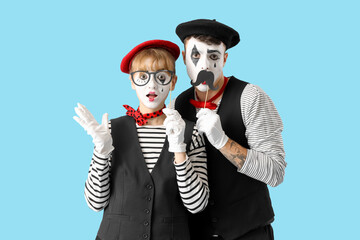 Couple of pantomimists on blue background