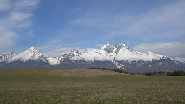 Snowy peaks of Slavkovsky stit and Lomnicky stit in High Tatras seen from open field near Velka Lomnica in Slovakia
