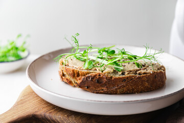 Rye toast with a turkey pate and microgreens, healthy breakfast