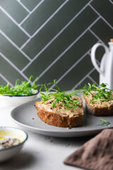 Rye toasts with a turkey pate and microgreens, healthy breakfast
