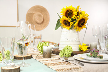 Beautiful table serving with sunflowers, candle and floral decor