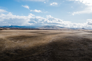 aerial desert landscape  with snowy mountains in background