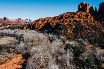 light hitting the red rocks of arizona with creek in foreground