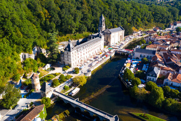 Scenic drone view of Brantome en Perigord on Dronne river with former Benedictine abbey on sunny...