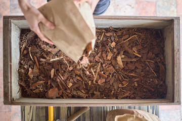 Top view of compost bin with dried leaves and wood chips