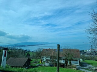 View of a house in the countryside.  Pfänder, Liechtenstein. Showcasing Bodensee, the alps and other mountains of 4 countries (Germany, Austria, Liechtenstein and Switzerland) 