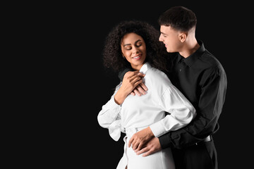 Young couple hugging on black background. Yin Yang concept