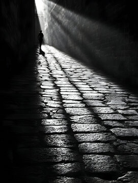 Fototapeta Solitary Figure Walking Through Sunlit Alleyway