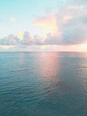 Aerial view of colorful sunrise over ocean in Punta Cana. Breathtaking scenery showcases sky painted with stunning hues, while gentle waves reflect morning light. Perfect postcard capturing tropical