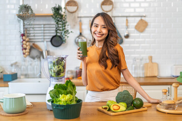 Portrait of beauty healthy asian woman making green vegetables detox cleanse and green fruit...