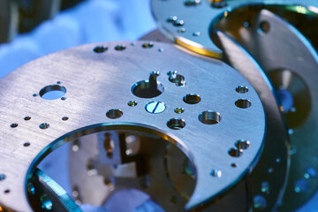 Intricate watch mechanism bases reveal craftsmanship in a metalworking factory during the assembly...