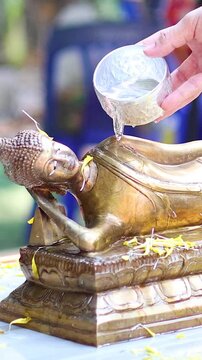 Ritual Water Pouring Over Buddha Statue